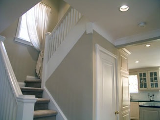painted hallway with white stair posts and light gray walls