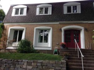 shows painting exterior windows in white paint and red door with brick on house in Ottawa Rockcliffe area by painters PG PAIINT & DESIGN