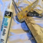 acrylic-latex caulk and caulking gun used by painters to seal gaps before painting