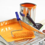 painting pan with paint, paint roller and paint can full of paint for house painting project